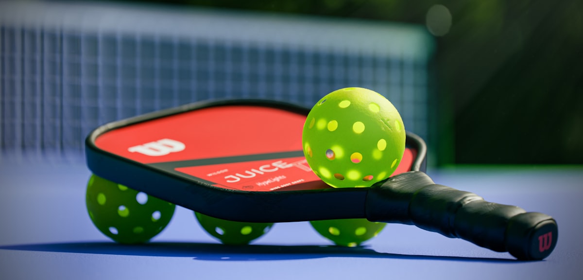 A pickleball paddle and balls